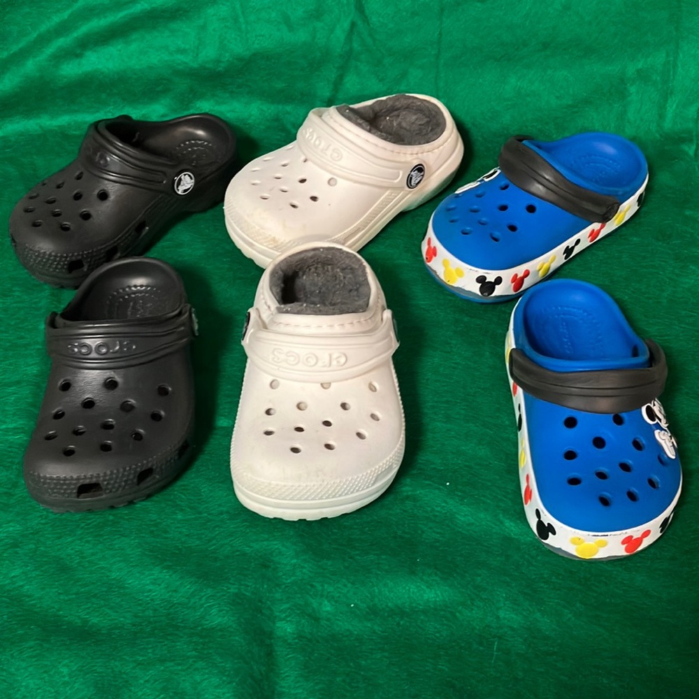 Three pairs of toddler Crocs sizes 7-8.